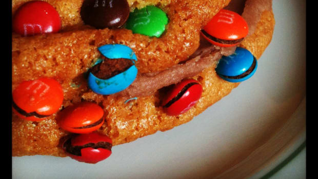 That’s two M&M cookies, with chocolate buttercream sandwiched between them.