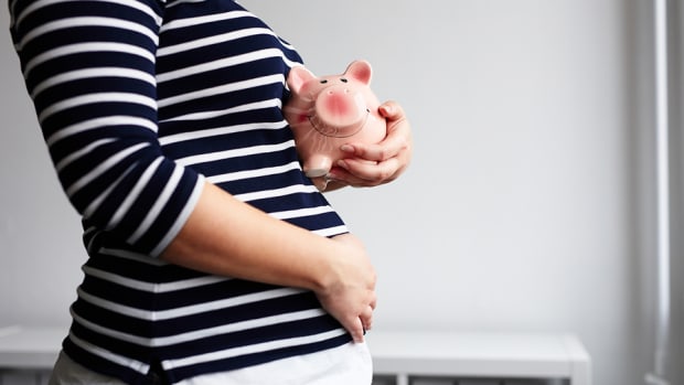 Pregnant Woman With Piggy Bank