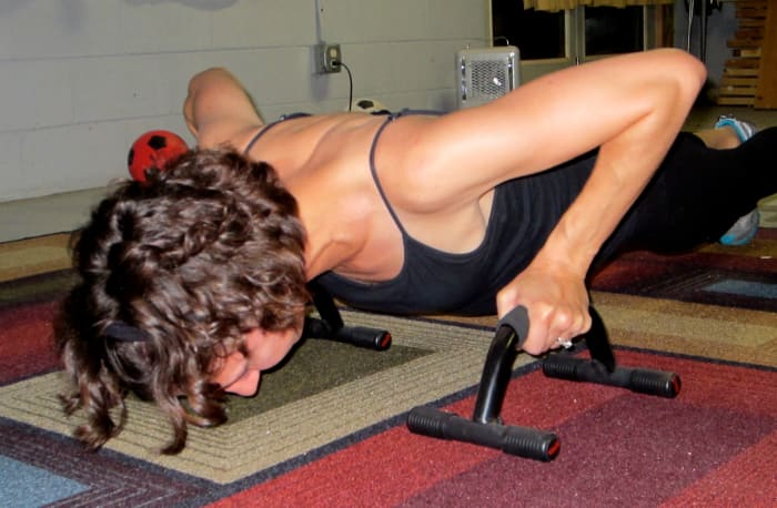 Me using push-up bars. My other pictures were unusable for this post because I look evil while working out.