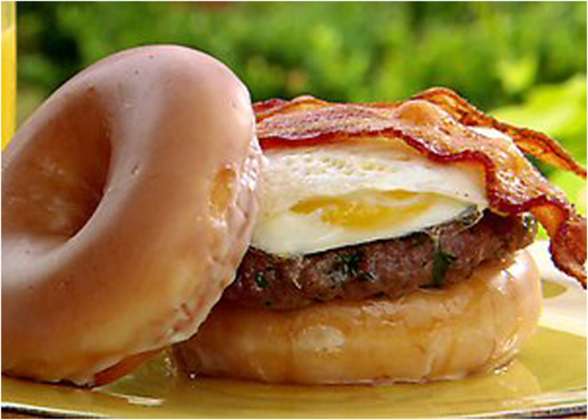 I originally saw this on man vs. food. This is the Paula Deen version. I'd take off the egg and replaces with white cheddar cheese. And yes, those are Krispy Kreme donuts as buns.